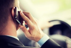 transportation and vehicle concept - man using phone while driving the car